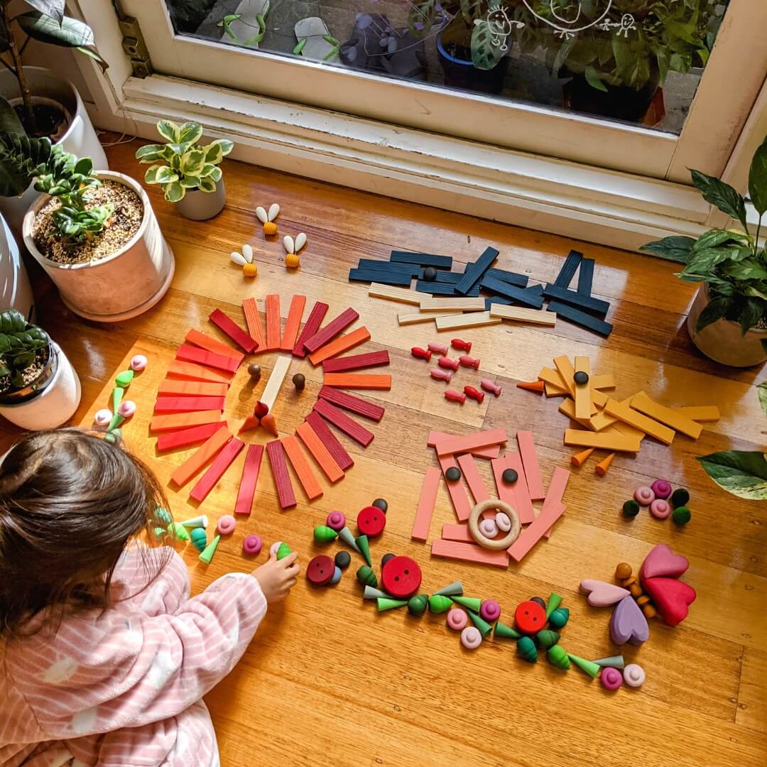 Child creating loose parts artworks with KAPLA wooden building planks from Wooden Playroom in Australia