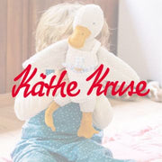 Child holding Kathe Kruse white cuddly duck toy from Wooden Playroom in Australia