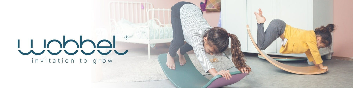 Children balancing and moving on Wobbel wooden balancing boards at Wooden Playroom in Australia