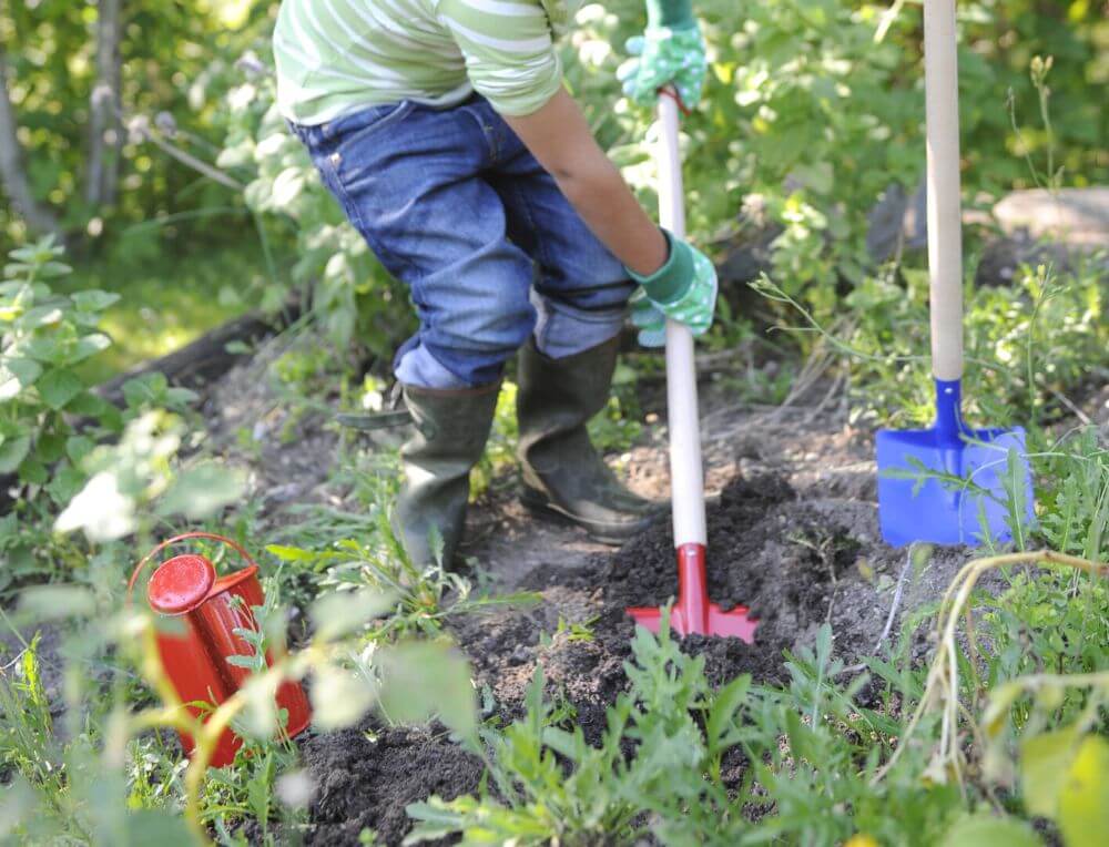 Child gardening with Gluckskafer tools at Wooden Playroom Australia