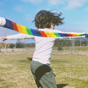 Child playing outdoors with Rainbow Tail Ball at Wooden Playroom in Australia