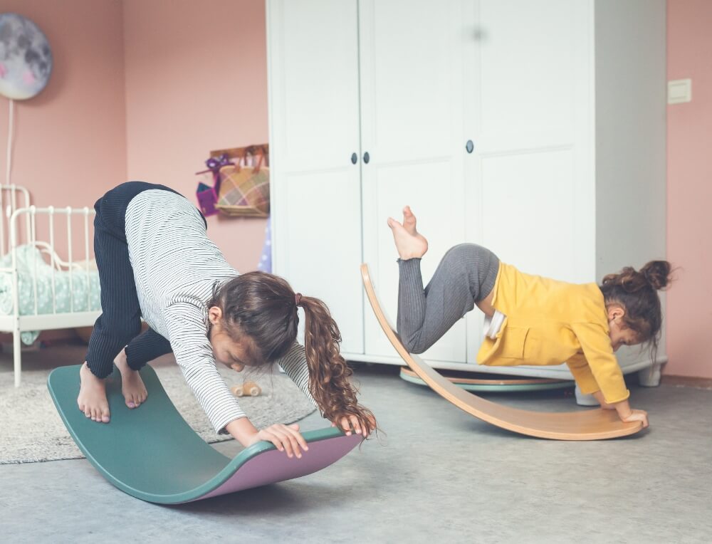 Children balancing and rocking on Wobbel wooden balance boards at Wooden Playroom in Australia