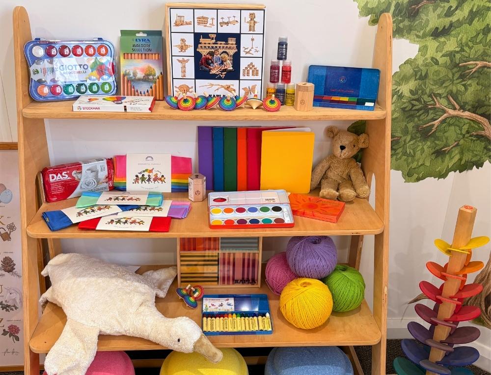 Shelf of bestselling toys and craft supplies at Wooden Playroom Wholesale