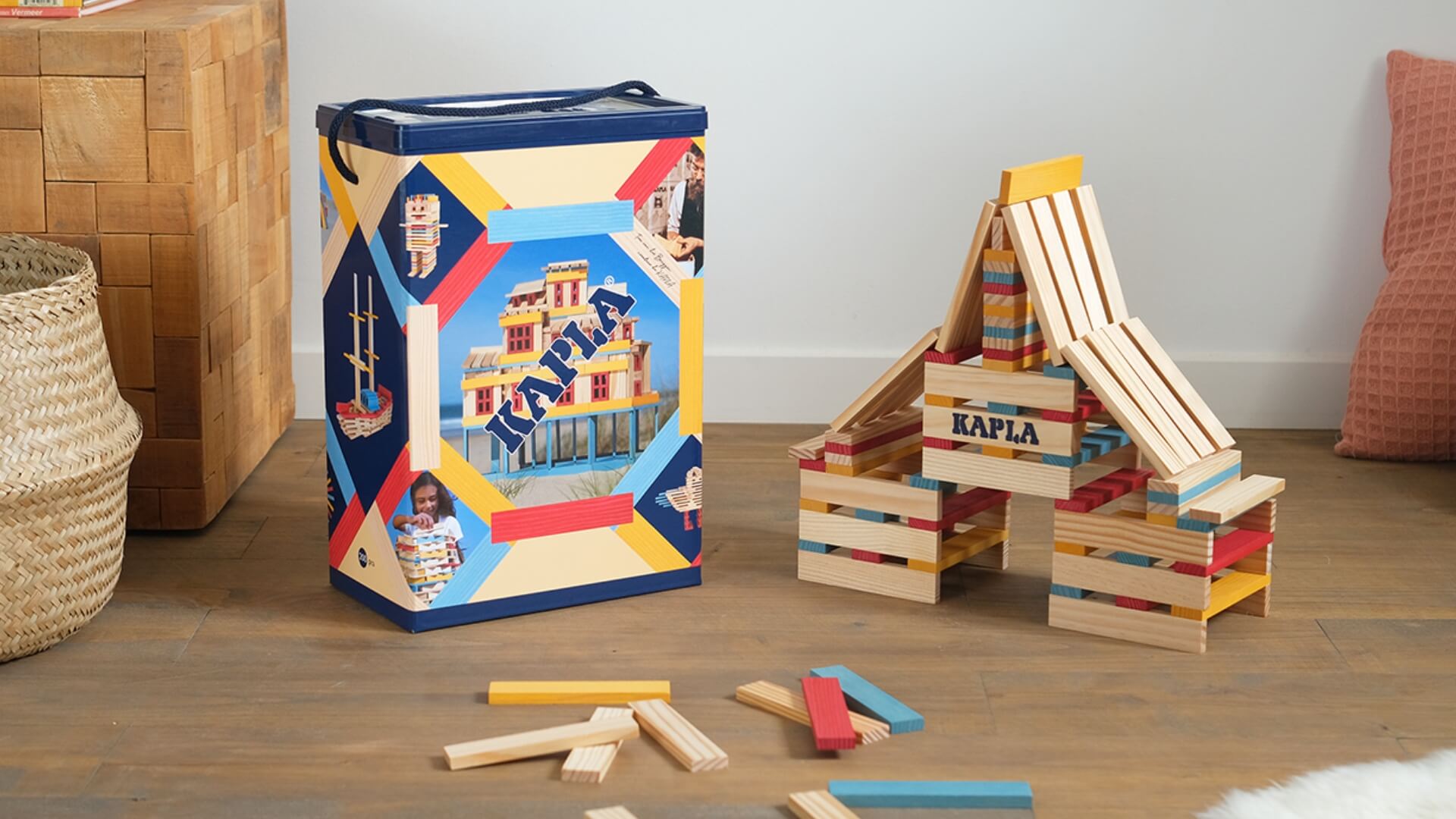 Kapla wooden building blocks set with colorful packaging on a wooden floor.
