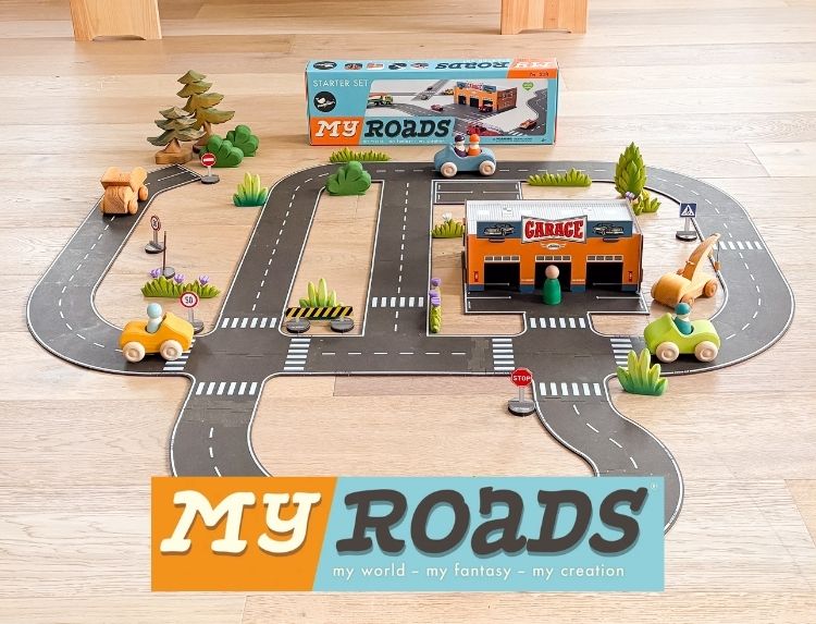 Toy road set with cars and a garage on a wooden surface, featuring 'My Roads' branding.